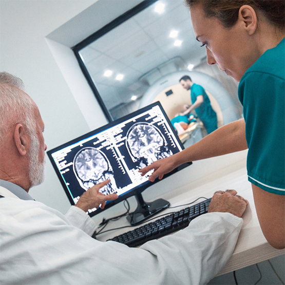 2 people looking at scan on screen